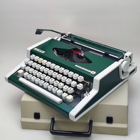 Product Title: Cursive*! Green Olympia Working Typewriter, İtalic font, Portable, Vintage typewriter with case birthday Christmas, New years gifts for her CURSİVE Olympia TYPEWRİTER ✅ İt's a Rare Model typewriter that Our typewriter writing CURSİVE font and in gorgeous condition. Restoration and Maintenance of the typewriter was done bu us like other machine.  ✅ Now İt is ready to writing... ✅ Font and text characters are very clearly. Also, we are sending with a new ribbon on it.. ✅ You can use to it for writing your articles and memories, you can use for decoration in your home, office, or you can take as a gift for your her / him...(birthday, mother, father, valentine days, New year, Christmas or speciel day...etc.) ✅ I am sure it will add a very nice atmosphere to your environment..  ✅ Typewriter Machine, New Years Gifts, Typewriter Writing, Olympia Typewriter, Unique Keyboards, Writing Machine, Working Typewriter, Valentine Days, Italic Font