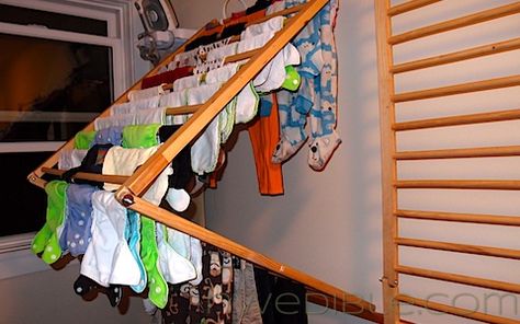 I repurposed a wooden baby safety gate system I got off Freecycle and a few pot-hooks into a wall-mounted clothes drying rack. The rack folds out to provide lots of room and airflow for delicates and other items I prefer to air dry, and folds flat against the wall when not in use to save space. After building this rack, I am certain that with a little creativity, many crib panels, baby safety gates and other slatted panels can be repurposed into clothes drying racks. The best part? The… Diy Clothes Drying Rack, Clothes Dryer Rack, Wall Mounted Clothes Drying Rack, Diy Baby Gate, Old Cribs, Wall Mounted Drying Rack, Baby Clothes Storage, Laundry Rack, Crib Rail