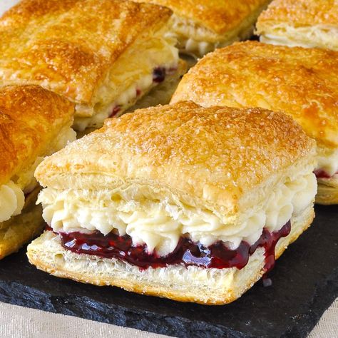 Homemade Flakies with raspberry compote & vanilla cream. A nostalgic tribute to the Vachon Flakie, one of my very favourite snack cake treats as a kid.#canada #canadianfood #puffpastry #puffpastryrecipes #easydessert Donut With Filling, Flaky Pastry Recipe Desserts, Cakes With Pastry Cream Filling, Newfoundland Desserts, Flaky Desserts, Cake And Pastry Flour Recipes, German Pastry Recipes, Phyllo Dessert Recipes, Cream Filled Pastries