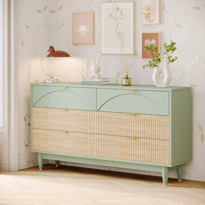 This 6-drawer dresser brings a refreshing blend of style and functionality with its modern design and mint green and light wood color scheme. It offers ample storage space with spacious drawers and a wide tabletop. Crafted with high-quality MDF, it promises durability and stability with its robust legs and adjustable foot pads. The dresser is versatile and could function as a TV stand, bedside table, or hallway storage cabinet. | Latitude Run® Isidro 6-Drawer Dresser Accent Chest Wood in Brown / Tv On Chest Of Drawers In Bedroom, Jewel Toned Furniture, Sage Green Bedside Table, Storage On Top Of Dresser, Green Wood Dresser, Dresser Under Window, Pastel Dresser, Pastel Interior Design Modern, Wayfair Dresser