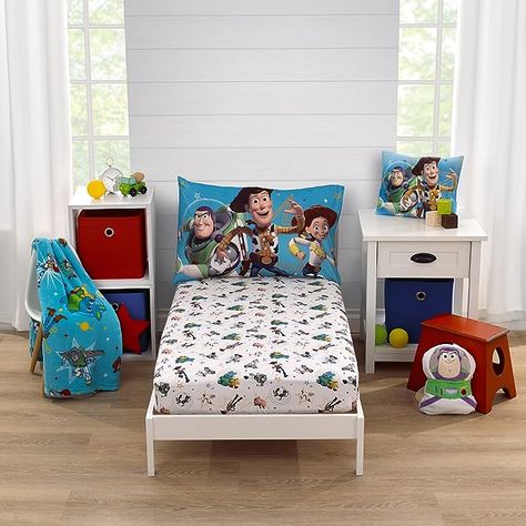 100% Polyester This 2-piece toddler sheet set includes a fitted bottom sheet and reversible pillowcase Features a playful pattern with Woody, Buzz Lightyear, and their friends! Designed in bright shades of blue, green, red, yellow, and white The sheet measures 28" x 52", and fits a standard size crib/toddler mattress Reversible pillowcase measures 20" x 30" and uses a standard size pillow Reversible Pillowcase, Toy Story Room, Soft Nursery, Toddler Sheets, Mini Crib Sheets, Mini Crib, Toddler Blanket, Fitted Crib Sheet, Baby Boy Rooms