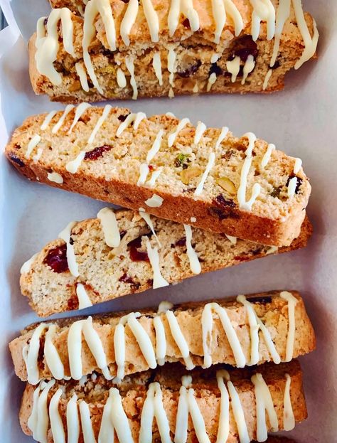 Christmas Cranberry & Pistachio Biscotti with Orange Drizzle Cranberry Pistachio Biscotti Recipe, Cranberry Orange Pistachio Biscotti, Cranberry Orange Pistachio Cookies, Orange Pistachio, Cranberry Pistachio Biscotti, Christmas Cranberry, Pistachio Biscotti, Orange Icing, Pistachio Cookies