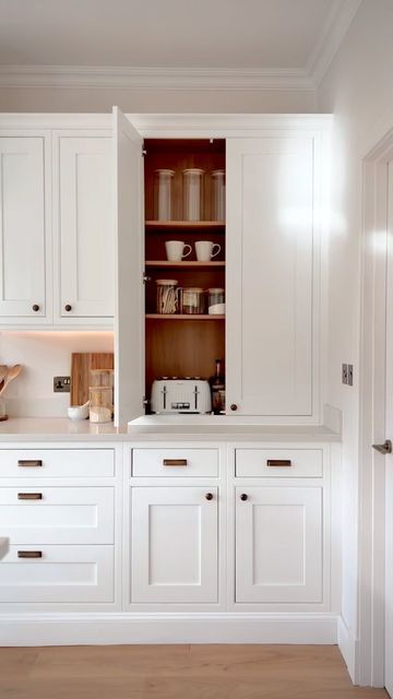 Craig & Simon | Our Bungalow Renovation on Instagram: "Cuppa anyone? ☕️  Our counter-top breakfast cupboard/larder, bespoke from @diykitchens to fit our 2.3m cabinetry height ~ keeps our toaster hidden whilst having all the things we use at breakfast time, in one place ✨  This couldn’t be configured on the DIY kitchens planner due to the taller height option we went for but can be requested with their customer services as a bespoke item ☺️   Kitchen: @diykitchens Helmsley White  Wall colour: ‘Bowbridge’ from @blenddecor (ad) Worktop: Angelo Quartz by Silkstone (30mm) Coving: Nayak @bandq_uk  Sockets/switches: G&H Brassware Antique Brass Flat Rectangle handles: @rowenandwren Antique Brass Knobs: @yesterhome Antique Brass   —  #DIYKitchens #DIYKitchensHelmsley #HelmsleyKitchen #HelmsleyWhite Hidden Cupboard Kitchen, Cream Cupboards, Breakfast Cupboard, White Traditional Kitchen, Larder Pantry, Inframe Kitchen, Diy Kitchens, Kitchen 2024, Kitchen Larder