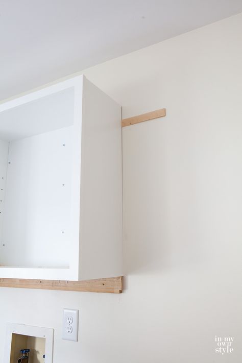 Wall Cabinet Laundry Room, Laundry Room Cabinets And Hanging Bar, Mounting Cabinet To Wall, Hanging Upper Cabinets, How To Hang A Cabinet On A Wall, Installing Cabinets In Laundry Room, How To Mount Cabinets On Wall, Building Wall Cabinets Diy, Laundry Wall Cabinets