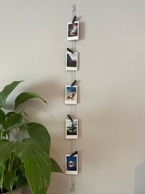 Vertical Cable Photo Display // Wire Photo Hanger // Polaroid Prints // Multiple Picture Display Standard length is 85cm but if you want a custom length then please order and add you desired length in the personalised message option. Vertical photo display with 5 black wooden pegs to hold photos/ Instax mini polaroids or mementos, A beautiful gift for yourself or a loved one. Everything required for quick and easy fitting. The discreet clear mounts blend in with your decor, and remove without da Polaroid Wall Art, Polaroid Wall Decor, Hanging Multiple Pictures, Wire Photo Holder, Polaroid Display, Polaroid Wall, Instax Photos, Photo To Art, Framed Photo Collage