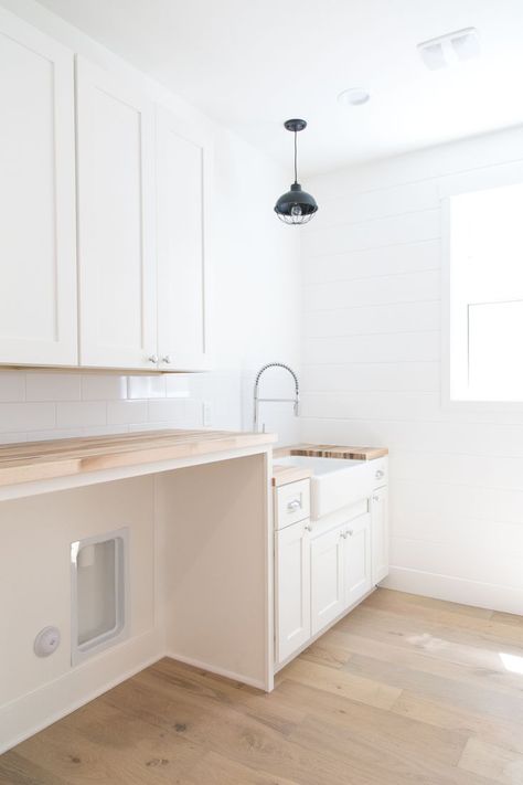 Past build in Phoenix, Arizona. Laundry room with farmhouse sink, white cabinets, butcher block countertop and black pendant light. Laundry Room With Sink And Counter, Laundry Room White Cabinets Wood Countertop, White Shaker Laundry Room Cabinets, Laundry Room Counter With Sink, Laundry Room With Wash Sink, Light Color Butcher Block Countertop, Butcher Block Counter In Laundry Room, Laundry Room Wood Countertop, Wood Countertops Laundry Room