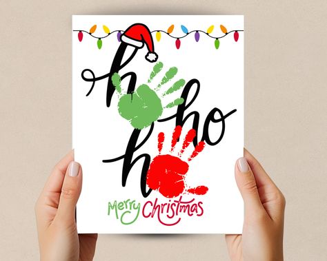 Celebrate this Christmas season with this Handprint craft Christmas printable. This handprint art is designed to bring creativity to your home, classroom, or craft time. This Ho Ho Ho Handprint Art is a great Christmas Decoration or gift. Whether you're a parent or teacher these charming handprint designs will make your Holiday decorations special and personalized. Great toddler handprint activity and homeschool craft.  What's Included:  High-Resolution PDF Files: File is design in high-resoluti Christmas Hand Print Ideas, Christmas Painting Crafts For Toddlers, Christmas Handprint Mug, Toddler Canvas Painting Ideas Christmas, Christmas Painting Toddler, Christmas Feet And Hand Crafts, Sibling Handprint Art Christmas Gifts, Sibling Christmas Crafts, Easy Toddler Christmas Ornaments