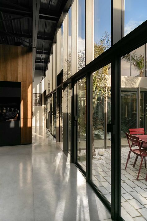 Throughout this modern warehouse conversion, walls of windows flood the interior with natural light, brightening the dark elements, while polished concrete flooring retains the industrial look. Modern Warehouse, Warehouse Conversion, Old Warehouse, Urban Renewal, Polished Concrete, The South Of France, Types Of Houses, Contemporary Home, Window Wall