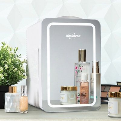 Multi-purpose cooling at home or on the go: This sleek, attractive unit is sized to fit right on your vanity or shelf and does double duty as a portable makeup case for travel. Extend the life of your fine cosmetics and quality skincare products by keeping them refrigerated in this 6.2 qt cosmetic mini fridge and feel like every day is a spa day when you apply them! The mirrored door features a dimmable LED ring light with touch control for a natural reflection that will not wash you out like in Cosmetic Fridge, Bathroom Skincare, Portable Shelves, Refrigerator Dimensions, Mirrored Door, Mini Cooler, Lighted Makeup Mirror, Beverage Refrigerator, Small Fridges