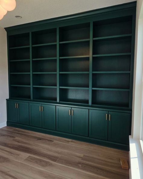 Creating a statement with this stunning custom built-in bookshelf, adding both style and functionality to this space! The deep green tone and sleek brass hardware elevate the entire room. Who else is loving this bold look? 💚✨ #AccentWallGoals #CustomBuiltIns #HomeDesign #InteriorGoals #AVPConstructionJAX Teal Built In Bookcase, Emerald Green Built Ins, Built In Bookshelves Green, Dark Blue Bookshelves, Dark Green Bookshelf, Green Built Ins, Green Bookshelf, Teal Shelves, Green Bookshelves