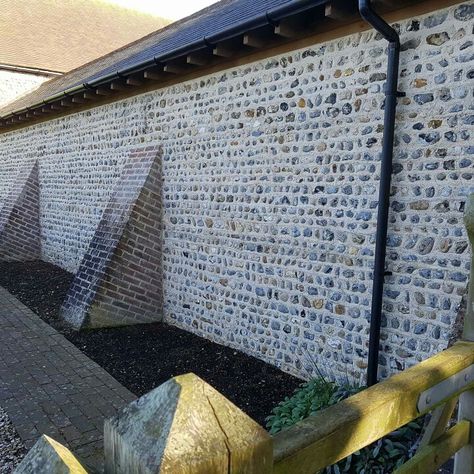 Fieldstone flint wall built in lime mortar built to match existing  with rampart buttresses  to barn conversion in the uk. Buttress Wall, Flint Garden, Flint Wall, Lime Mortar, Paul Reynolds, Crossfit Logo, Barn Conversions, Garden Walls, Barn Renovation