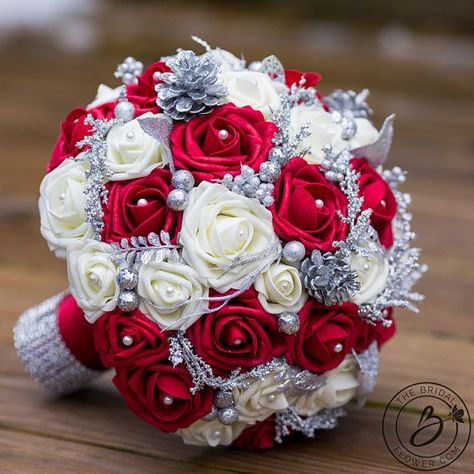 “Holiday Bliss” large bridal wedding bouquet with red and cream roses and silver glitter accents  The holidays are already overwhelming, and to add to the craziness now you are also planning a wedding! This bouquet is the perfect solution to your wedding flower stress this holiday season. This bouquet will feel like it was delivered from the perfect red and cream holiday winter wonderland of your dreams! Red and cream roses packed with beautiful glittery silver accents including leaves, berri... Winter Wedding Planning, Red And White Weddings, Red Bouquet Wedding, Winter Wedding Bouquet, Winter Bouquet, Silver Wedding Anniversary, Best Wedding Favors, Cream Wedding, Winter Wonderland Wedding