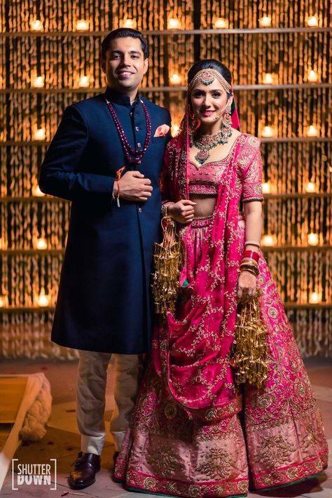 Couple portrait on wedding day with bride in a pink benarasi lehenga and groom in navy blue sherwani |WedMeGood| Rishika & Akhil|#wedmegood #indianweddings #lehenga #bridallehenga #pink #green #bridal #weddingday #benarasi #jewellery #emeralds #groomwear #sherwani Blue Sherwani, Indian Engagement, Indian Wedding Gowns, Sherwani Groom, Blue Bride, Couple Wedding Dress, Indian Bridal Lehenga, Indian Wedding Planning, Pink Bride