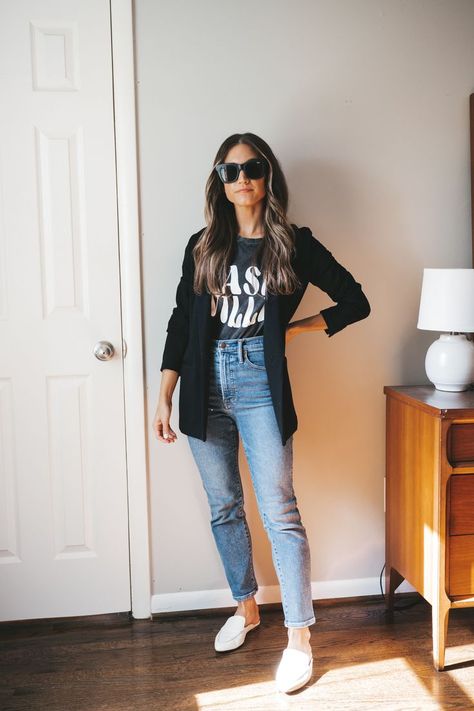 ashley wearing a black graphic tee that reads "Nashville' in white, a black blazer, medium wash denim and white mules with black square frame sunglasses standing next to a vintage wood dresser with a white table lamp Blazer With Converse Outfit, Jumper With Blazer Outfits, Black Denim Blazer, Black Blazer Spring Outfit, Blazer And Mom Jeans Outfit, Women’s Casual Blazer Outfit, Simple Blazer Outfits, Casual Lunch Outfit Fall, Casual Black Blazer Outfit Women