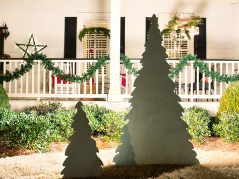 The holiday experts at HGTV.com share step-by-step instructions for making a modern, minimalist backlit plywood Christmas tree. Outdoor Trees Christmas Decorations, Plywood Christmas Tree Pattern, Christmas Yard Silhouettes, Plywood Tree Cutout, Christmas Plywood Cutouts, Bright Christmas Decorations, Christmas Tree Yard, Outdoor Christmas Diy, Potted Christmas Trees