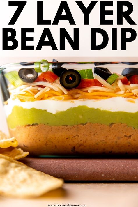 This easy 7 layer dip has a base of creamy bean dip topped with sour cream, guacamole, cheese, and veggies. Ready in under 10 minutes, this dip can be made ahead of time and set out for easy snacking when needed! Easy 7 Layer Dip, 7 Layer Bean Dip, 7 Layer Dip Recipe, 7 Layer Dip, Layer Dip, Bean Dip, 7 Layer, 7 Layers, Lunch To Go