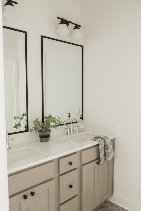 Bathroom Taupe Cabinets, White Bath Vanity Ideas, Bathroom With One Mirror, Beige Bathroom Cabinets Black Hardware, Neutral Bathroom Cabinets, Bathroom Decor White Cabinets, Mushroom Bathroom Cabinets, Taupe Cabinets Bathroom, Beige Bathroom Black Fixtures