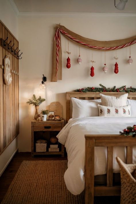 A farmhouse-style bedroom adorned with holiday decor, featuring rustic garlands, festive ornaments, and a simple wreath. Christmas Bedroom Decor Simple, Christmas Headboard Decor, Christmas Bedroom Wall Decor, Unique Bedroom Decor, Holiday Bedroom Decor, Christmas Bedroom Decor, Holiday Decor Ideas, Holiday Bedroom, Unique Bedroom