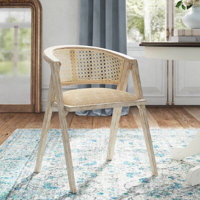 Kelly Clarkson Home Add this unexpected dining chair to your dining room, rounding out your table in French country style. This design is crafted with a solid wood frame, and finished in a whitewashed hue for farmhouse appeal. It features a curved, caned back in a natural hue, which pairs perfectly with its padded, linen-wrapped seat for a light and airy color palette. This chair is framed on each side by triangular legs for a casual yet architectural look.  Hand-curated by Kelly Clarkson. Color Coffee Table Metal Frame, Kelly Clarkson Home, Linen Armchair, Rattan Dining Chairs, Table Diy, Parsons Chairs, Design Board, Kelly Clarkson, French Country Style