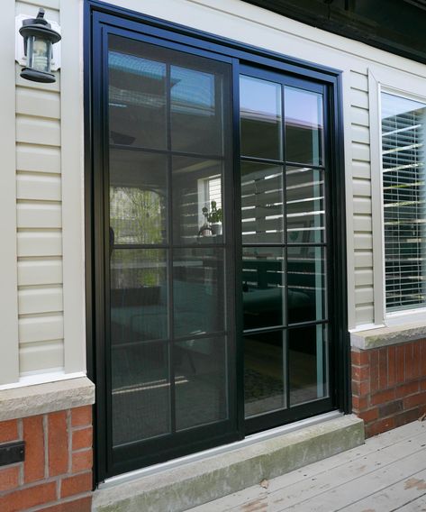 Level up up your backyard with a black double sliding patio door with SDL grilles. Let us help you with your next backyard project. Contact us today for all your patio door needs and questions. Black Windows White Siding, Black Sliding Doors Exterior, Glass Sliding Doors Exterior Patios, Black Sliding Doors Patio, Black Patio Doors, Black Sliding Doors, Double Sliding Patio Doors, Exterior Sliding Glass Doors, French Doors Patio Exterior