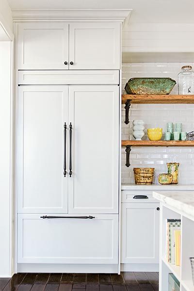 the Polished Pebble: Redesigned Online: This Old House Magazine  Feature    The open shelving with reclaimed wood is beautiful and so fun to style with   bright dishes and vintage finds.    I received quite a few emails about the brackets  which were purchased here  Traditional subway tile with a nice clean beveled edge looks much cleaner and current.  Amber found a great source for the reclaimed wood in her local area and it was cut to her specifications for the open shelving Hidden Fridge, Kitchen With Open Shelving, Bar Restaurant Design, White Refrigerator, Architecture Restaurant, Design Café, Built In Refrigerator, Kitchen Redesign, Open Kitchen Shelves