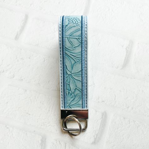 "Lt Blue Floral Embossed Vegan Leather Wristlet Keychain Key chain, Bridesmaid Gift Idea Gifts Under 20 For Her,Wristlet key fob, lanyard fob You are purchasing ONE wristlet keychain as shown in the photos above.  Designed with a combination of vegan leathers, this wristlet features an appliquéd center that can be monogrammed or personalized for an additional fee.   This wristlet is 5x1.25\" not counting the hardware.   Due to the nature of the different vinyls, pattern placement will vary.  No two are exactly alike.  These are handmade and the photos in the listing are examples of what you can expect but do not reflect the exact pattern placement.  I do have a no-return policy because of the customized nature of the items I sell.  However, if for any reason there is an issue with your ord Leather Keychain Ideas, Key Chains Aesthetic, Car Keys Keychain Ideas, Cute Keychains For Car Keys, Christmas List Items, Leather Wristlet Keychain, Key Wristlet, Wrist Keychain, Girly Car Accessories