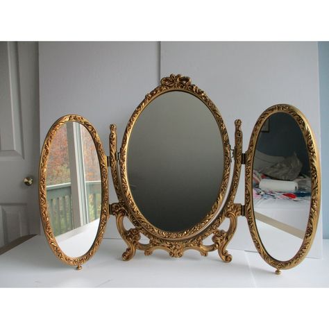 An Italian made, French Louis XVI style folding triptych table or vanity mirror.  This piece is made of metal and resin (plastic).  It features two folding oval side mirrors and a central mirror that can swivel upward or be completely removed from the mount; see pictures.  A fun and versatile mirror sure to please the eye.  This triptych mirror is in good vintage condition with some minor wear to the gilt paint on the body of the piece and a few minor specks on the mirrors themselves.  Please se Folding Mirror Vanity, Cool Vanity Mirror, Vintage Victorian Furniture, Vintage Room Accessories, 2 Vanities Side By Side, Vintage Gold Wall Decor, Vanity Mirror Vintage, French Chic Home Decor, Whimsigoth Furniture