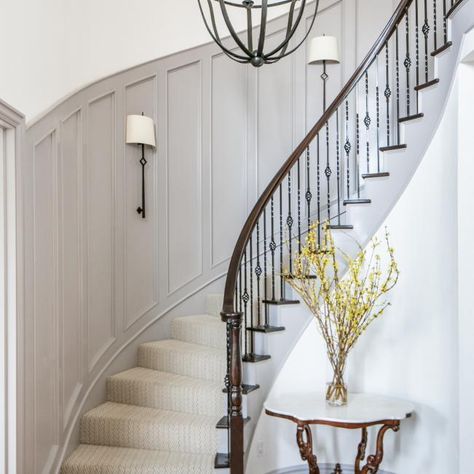 A Grand Curved Staircase Brings Art Deco Vibes to this New Build House | HGTV Curved Staircase Foyer, Staircase Walls, Stair Redo, Wallpaper Staircase, Foyer Table Decor, Stairway Railing, Staircase Lighting Ideas, Traditional Foyer, Stairwell Ideas