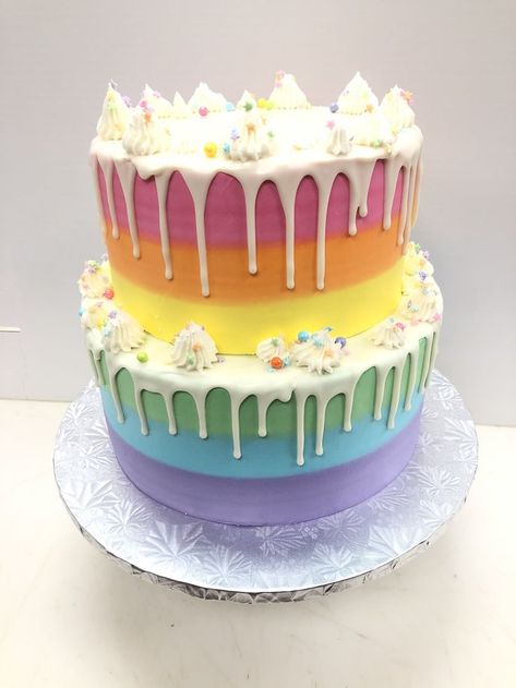 2 tier buttercreasm rainbow ombre with white chocolate ganache drip with decorations in buttercream and sprinkles Rainbow Tiered Cake, Rainbow Two Tier Cake, 2 Tier Rainbow Cake, White Chocolate Cake Decoration, Georgia Cake, Ombré Cakes, Rainbow Drip Cake, White Chocolate Ganache Drip, Rainbow Sprinkle Cakes