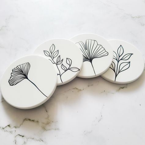 This Minimalist Coaster Set is designed to elevate your home decor. Its sleek and modern design add a touch of sophistication to any tabletop. The set has a clean and crisp look that suits any interior aesthetic. Crafted from high-quality materials, this coaster set is designed to stand the test of time. The minimalist style of each coaster gives you the perfect accent to any table setting. Comes in a set of 4 -Durable -Cork backing -Waterproof -Minimalist Design If you have any questions, feel free to message me and I'd be happy to answer them. Creative Coaster Design, Unique Coaster Designs, Designs For Coasters, Diy Coaster Designs Ideas, Diy Coaster Painting Ideas, Painted Wooden Coasters, Diy Pottery Painting Ideas Simple, Coaster Art Ideas, Ceramic Coaster Ideas