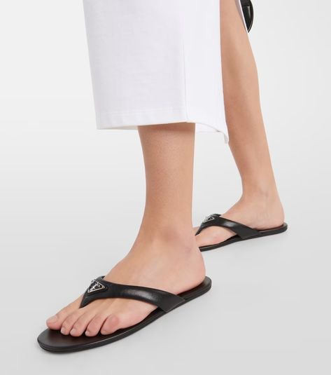 Logo padded leather thong sandals in black - Prada | Mytheresa Luxury Modern T-strap Sandals With Leather Sole, Prada Padded Nappa Leather Sandals, Designer Luxury Black T-strap Sandals, Luxury Designer Black T-strap Sandals, Luxury T-strap Sandals With Leather Sole For Beach, Fashion Sandals Flat, Leather Thong Sandals, Nylon Tote Bags, Prada Designer