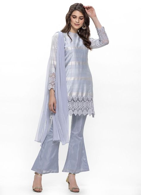 A lovely light blue lurex cotton slub kurta set is all you need to look fab this season. It consists of a shift dress with crew neck and crochet lace at top and full fitted sleeves hem. It is paired with matching dupion bell bottom trousers and light blue chiffon dupatta. Indian Clothing Brands, Bell Bottom Trousers, Ethnic Wear Indian, Fitted Sleeves, Chiffon Dupatta, Indian Clothing, Bell Bottom, Kurta Set, Dress Cuts