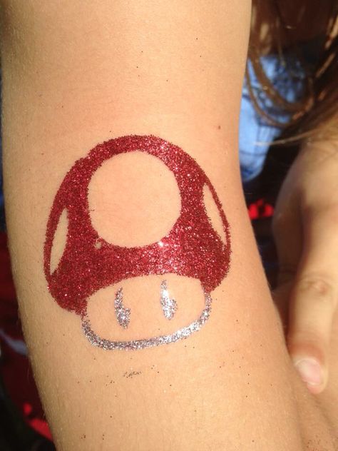 Mario mushroom, glitter tattoo!  www.facebook.com/glittergalsparkle Cute Glitter Tattoo, Glitter Tattoo Permanent, Glitter Tattoo Ideas, Easter Face Paint, Superhero Face Painting, Glitter Tattoo Stencils, Glitter Bar, Arm Painting, Kids Face Paint