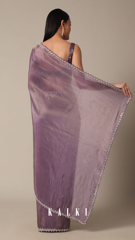 Indulge in the allure of this Orchid Glass Crush Saree. The mirror and stone embellishments on the scallop border create a rich tapestry of craftsmanship. The vibrant purple and lavender hues elevate the softness of the fabric, making it a statement piece for celebratory occasions. With detailed precision and an included unstitched blouse fabric, this saree assures a tailored fit. Lavender Net Saree, Shimmery Saree, Crush Saree, Desi Fits, Saree Wearing, Saree Wearing Styles, Scallop Border, Purple Saree, Blouse Design Images