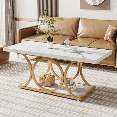 [Sophisticated Modern Coffee Table]: With a cultured white marble veneer top and gold geometric metal legs, adding a touch of modern luxury to the entire coffee table, create a cozy, warm feel in your living space.
[2-Tier Center Table]: Spacious tabletop and bottom shelf perfect for keeping your living room supplies organized and your daily essentials close at hand. The minimalist coffee table help to create a clean and clutter-free space that’s perfect for relaxing. Marble Veneer, Modern Wood Coffee Table, Rectangle Coffee Table, Minimalist Coffee, Gold Dining, Minimalist Coffee Table, Room Supplies, Simple Coffee Table, Coffee Table Rectangle