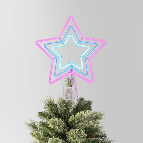 This 12.5-Inch Pre-lit LED Neon-Style 5-Point Star Christmas Tree Topper from Wondershop™ adds a bright and eye-catching finishing touch to your tree. Made from metal, this tree topper is designed as a five-pointed star with LED bulbs in neon pink and blue hues. Featuring a pre-lit design, it also has an adjustable clip for easy attachment to the top of your Christmas tree. Welcome to the Wondershop™. Pink Christmas Topper, Christmas Tree Topper Pink, Christmas Tree Topper Red, Star Christmas Tree Topper, Star Christmas Tree, Cute Little Houses, Neon Style, Christmas Topper, Star Tree Topper