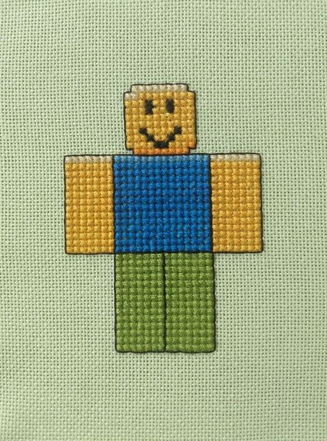 Cross stitch of a noob from Roblox. Roblox Cross Stitch, Roblox Perler Beads, Roblox Crochet, Roblox Pixel Art, Cross Stitch Games, Pink Cross Stitch, Gamer Art, Roblox Party, Roblox Character