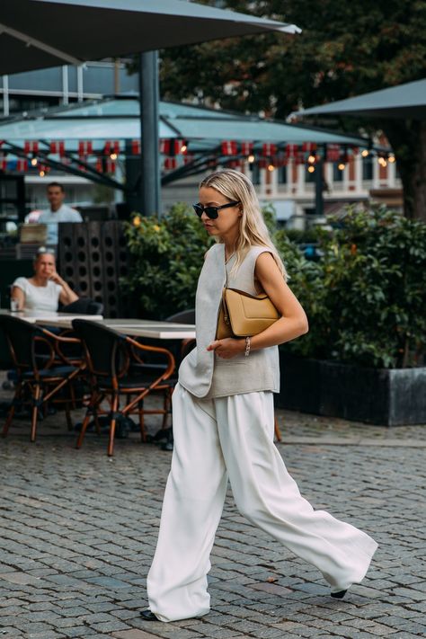 The Best Street Style at the Spring 2022 Copenhagen Fashion Shows | Vogue Street Style Chic Summer, Spring Summer Style 2023, High Fashion 2022, Minimal Fashion Summer, Copenhagen Fashion Week Street Style, Copenhagen Street Style, Trousers White, Reportage Photography, Copenhagen Fashion