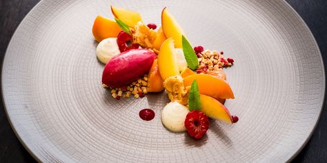 Graham Hornigold's glorious peach recipe is a real celebration of summer, when peaches are in their peak season and raspberries are plentiful. A fantastic, vibrant summer dessert. Summer Plated Desserts, Peach Dessert, Peach Sorbet Recipe, Fancy Desserts Recipes, Fine Dining Desserts, Peach Sorbet, Dessert Presentation, Freeze Dried Raspberries, Dessert Plating