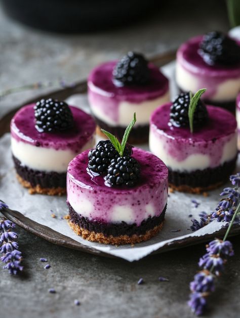 Mini Blackberry Lavender Cheesecakes   𝗜𝗻𝗴𝗿𝗲𝗱𝗶𝗲𝗻𝘁𝘀 💯  1 cup graham cracker crumbs 1/4 cup butter, melted 1 1/2 cups cream cheese, softened 1/2 cup sugar 1/4 cup blackberry puree 1 tsp lavender extract 2 eggs Fresh blackberries and lavender sprigs for garnish Blackberry Puree, Blackberry Lavender, Bake Cheese, Blackberry Compote, Lavender Sprigs, Blackberry Cheesecake, Miniature Inspiration, Lavender Extract, Drink Photography