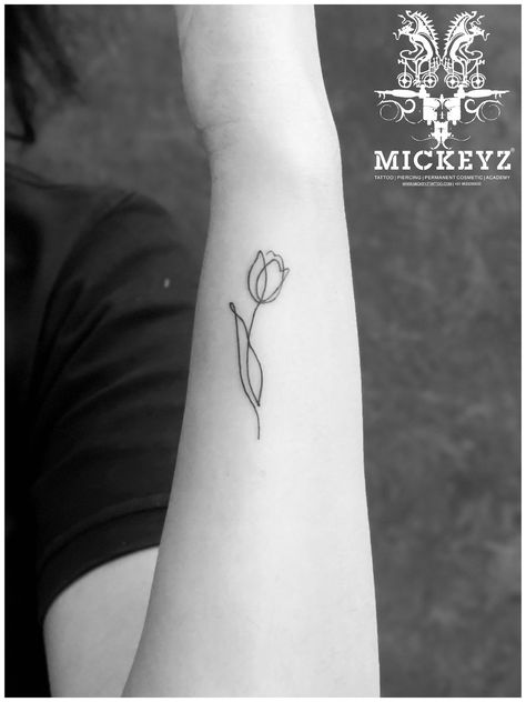 #tattooideas #tattoostudio #tattoos  #learntattoo #famous #academy #inked #india #lifestyle #ink #mumbai #realistictattoo #realismtattoo #tattoostyle #mickeyztattoo #tattoofore #mickeyzre #girltattoo #tattoolife #tattooedesigns #linearttattoo #amazon #tattooforgirls #smalltattoo #armtattoo #flowertattoodesign #facebook #instagram Lineart Tattoo Minimal, Fine Line Tulip, Fine Line Tulip Tattoo, Minimal Tattoos, Tulip Tattoo, Tattoo Minimal, Fine Line Tattoo, Line Tattoo, Simplistic Tattoos