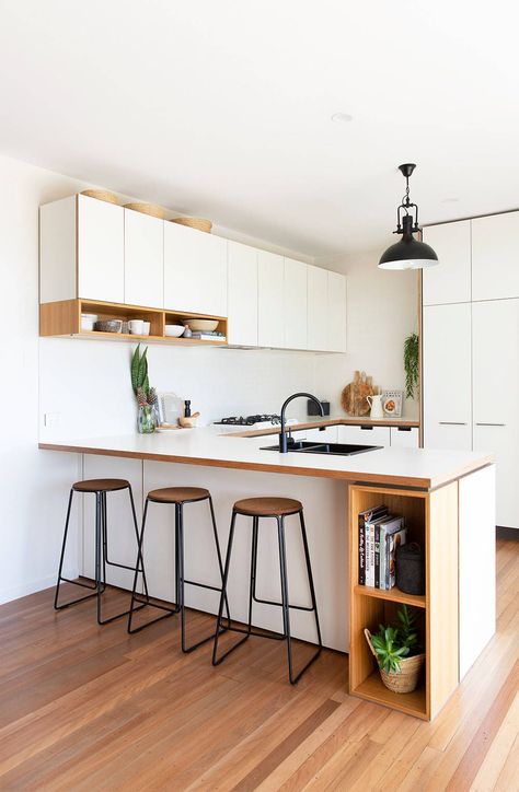 White Kitchen Cabinets and Countertop with Wood Details
The addition of a sink is one of the many ways you can make your kitchen peninsula as functional as possible if you are considering installing one. Small Kitchens With Peninsulas, Kitchen With Peninsula, White Wall Paneling, Beach Style Kitchen, Kitchen Peninsula, Beach House Kitchens, Organization Kitchen, U Shaped Kitchen, White Backsplash