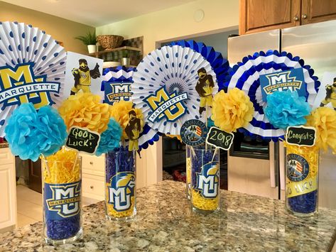 Graduation party centerpiece Marquette University College Graduation Party Ideas For Guys Decoration Center Pieces, Guy Graduation Centerpiece Ideas, College Centerpieces Table Decorations, Trunk Party Ideas College, University Graduation Party, Tailgate Decor, Grad Party Centerpieces, College Gymnastics, Grad Decor