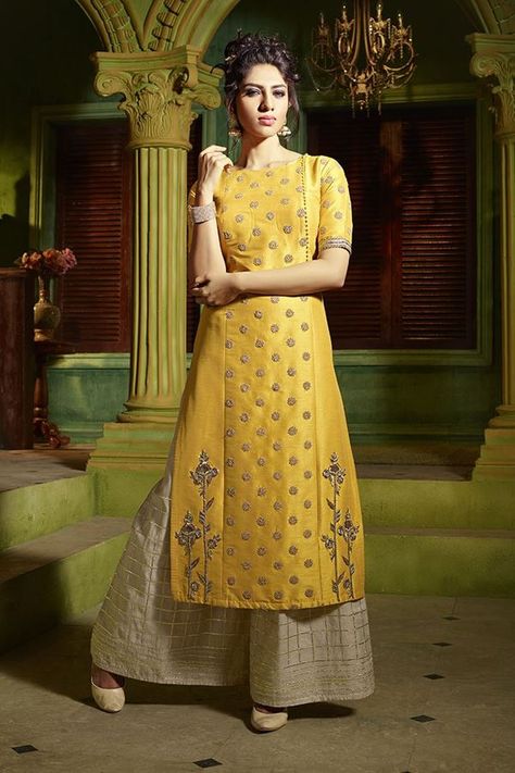 Glow with taste in this classy yellow designer straight cut suit featuring plain side panels enriched with a long butta on each side bottom while the centre panel shines in zardosi & stone worked motifs along with side-front part bearing self fabric buttons in a look of cosmic glamour! This suit is accompanied by contrasting beige palazzo pants with zari detailing & no dupatta. Panel Kurti Design, Indian Designer Suits, Salwar Designs, Long Kurti, Kurti Designs Latest, Designer Suit, Designer Jacket, Salwar Kamiz, Kurti Design