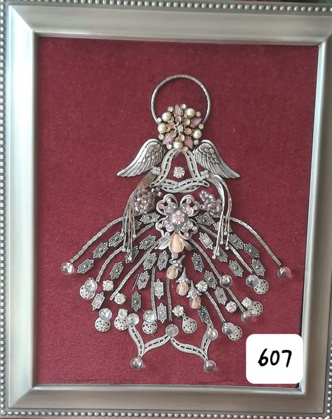 Assembledge Art - Jewelry Angel - Framed OOAK Wandmade #607 11.5 x 9.5 Brushed silver frame. The angel is made up of a combo of vintage jewelry, pink beads and many fantners all mounted on deep red velvet. The angels arms are lose and float. Free standing or wall hang. A very unique and beautiful piece of art. Handmade OOAK 607 Deep Red Velvet, Old Jewelry Crafts, Costume Jewelry Crafts, Jeweled Christmas Trees, Jewelry Frames, Jeweled Christmas, Jewelry Christmas Tree, Vintage Jewlery, Junk Jewelry