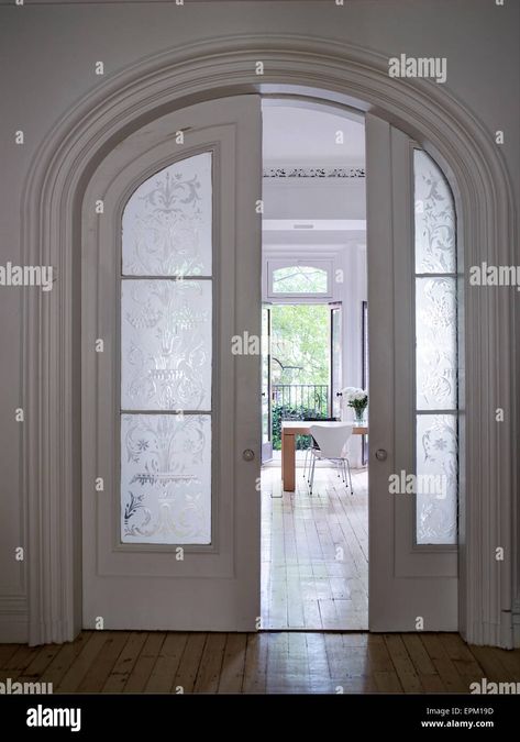 Download this stock image: Wood and glass sliding doors in arched doorframe, Chelsea Townhouse, New York, USA - EPM19D from Alamy's library of millions of high resolution stock photos, illustrations and vectors. Townhouse New York, Arched Interior Doors, Chelsea Townhouse, Arched French Doors, Glass Pocket Doors, Glass Sliding Doors, Arch Interior, Arched Doors, Door Design Modern