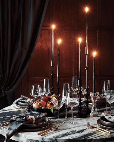 Modern Halloween Decorations | CB2 Black Tablescape, Modern Halloween Decor, Black Pillar Candles, Black Taper Candles, Round Marble Dining Table, Modern Halloween, Large Candle Holders, Marble Dining, Wine Glass Set