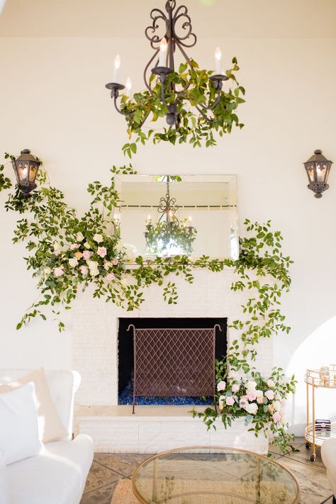 Romantic courtyard wedding reception under canopy of twinkle lights with paper cranes and vines overhead.  Velvet linens, modern stationary, vellum menus, acryllic table numbers, fine china, and lush garden blooms - roses, ranunculus, and spring flowers.  Blush and white wedding design by Tyler Speier, photo by David Mendoza.  Fireplace lounge design at Villa and Vine. Courtyard Wedding Reception, Villa And Vine, Romantic Courtyard, Paper Crane Wedding, Fireplace Lounge, Blush And White Wedding, Elegant Wedding Design, Planning 2023, Downtown Santa Barbara