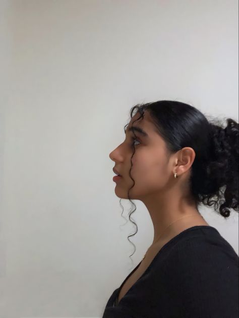 A Latina girl wearing a black slit shirt and styled her curly hair up with two strands out to give it volume . Hooked Nose Side Profile Drawing, Latina Reference Photo, Latina Side Profile, Round Face Side Profile, Side Profile Looking Down, Latina Nose, Side Profile Looking Up, Person Looking To The Side, Profile View Reference