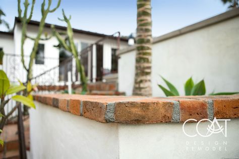 Aged red clay brick makes a fitting wall cap in a Spanish style landscape. It jives perfectly with Terracotta, white stucco and sculptural plantings. @brooksidedesignbuild @spgardens Spanish Style Retaining Wall, Spanish Retaining Wall, Spanish Textured Walls, Terracotta Garden Wall, Spanish Style Landscape, Adobe Bathroom, Retaining Wall Bricks, Villa Gate, Cali House